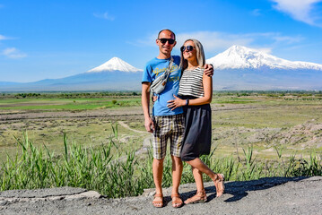 A man with a girl on the background of a beautiful view of mount Ararat in the afternoon. May 6, 2019. Armenia.
