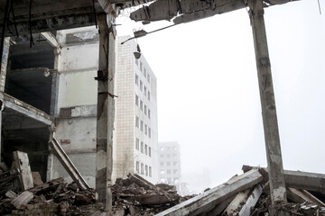 The destroyed big concrete building in a foggy haze. Background.