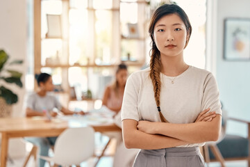 Portrait, leadership and meeting with an asian woman in business standing arms crossed in a boardroom. Confident, leader and planning with a young female employee ready for strategy or training