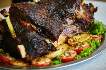 Serving meat dishes in the restaurant, baked pork ribs with vegetables.
