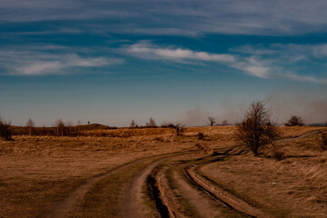 Fototapeta na wymiar Autumn smoke over the sunny hills. Nature landscape