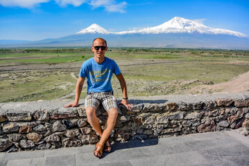 Young man on the background of a beautiful view of mount Ararat in the afternoon. May 6, 2020....