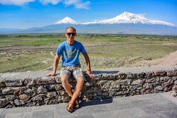 Young man on the background of a beautiful view of mount Ararat in the afternoon. May 6, 2020. Armenia.