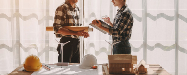 Confident asian team of architect working together in a office.Then discussing about new startup project on desk.in office, architectural concept.