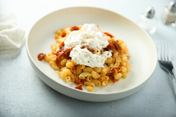 Pasta with fresh cheese and tomatoes