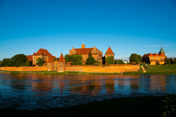 Fototapeta na wymiar Marienburg Castle the largest medieval brick castle in the world in the city of Malbork at sunset
