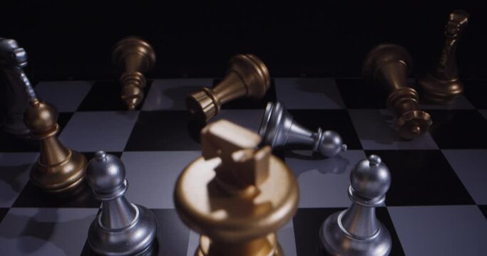 Sliding shot of toppled chess pieces with a lone king ruling triumphant.