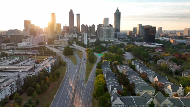 Aerial establishing shot of Atlanta Georgia. Skyline at sunset. Highrise skyscrapers and urban downtown housing, Interstate 20.