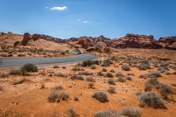 Driving and walking through the Valley of Fire State Park, formed by shifting sand dunes to red sandstone formations, also called Aztec Sandstone, Nevada, USA