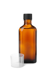 Bottle of syrup with measuring cup on white background. Cough and cold medicine