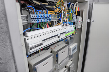 Panel with electric meters and many wires in fuse box