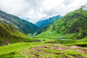 Obraz premium July 14th 2022, Himachal Pradesh India. Wide angle view of Parvati bagh valley during Shrikhand Mahadev Kailash Yatra in the Himalayas.