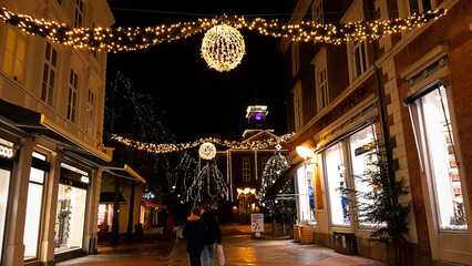 Obraz na płótnie Canvas Danish city street decorated with christmas lights glowing at night in December