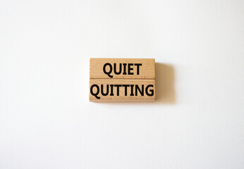 Quiet quitting symbol. Concept word Quiet quitting on wooden blocks. Beautiful white background. Business and Quiet quitting concept. Copy space.