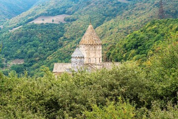 Fototapeta na wymiar Armenia, Tatev, September 2022. Armenian temple among the apple orchard.