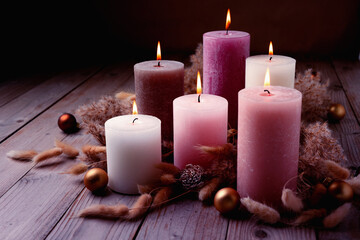 Modern Boho Christmas Advent candle decoration in trend colors. Violet, pink and white candles....