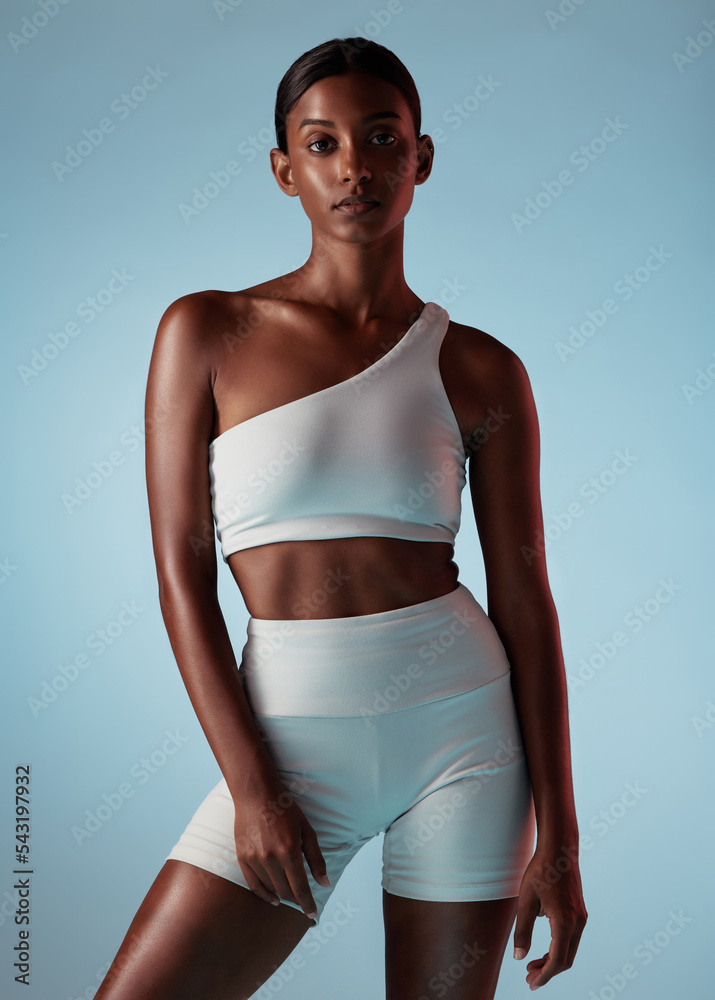 Poster Fitness, health and sports with portrait of woman for wellness, workout and exercise. Gym, training or fashion with Indian girl model for lifestyle, strong and power against blue background in studio