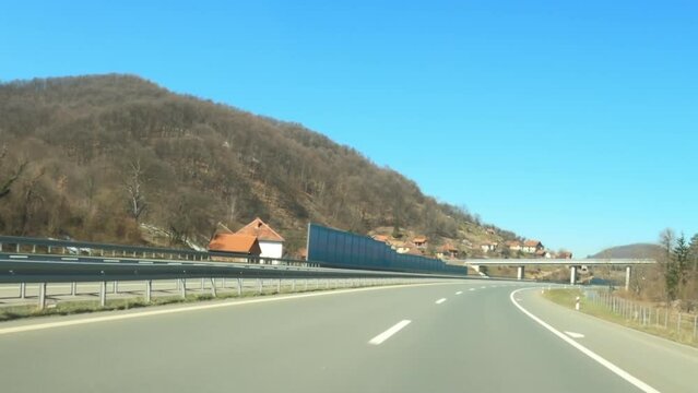 Driving Down The Highway Through Serbia In Winter, With Snow Melting On Surrounding Hills, Dashcam Pov Driving Plate Footage In Real Time