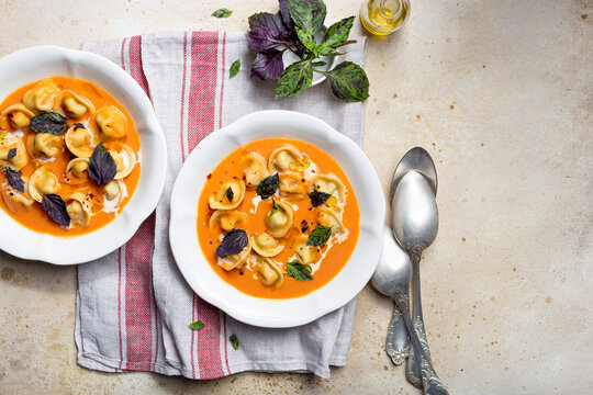 tomato soup with cappelletti pasta, cream and basil