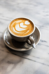 coffee in white cup on table in window cafe.