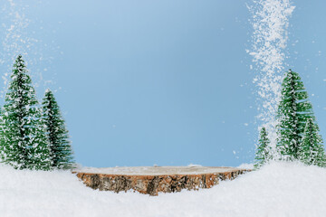 Wooden podium with fir tree and falling snow. Festive display, winter and holidays concept