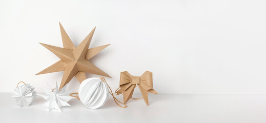 Christmas Paper Star and Ball Decoration. Handmade Christmas Nordic Decor on a Light Background...