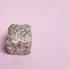 1. Granite cube on a pink background