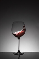 Wave of red wine inside a glass. Moving liquid. Celebration drink concept.