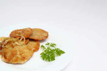 Potato pancakes or latkes or draniki on white plate. Top view. Copy space. Fried potato pancakes