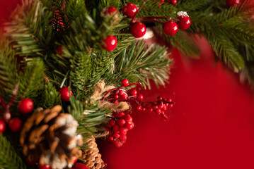 Christmas red background with fir branches and decorations
