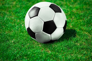 Fototapeta na wymiar Classic Football Ball on green grass at Stadium