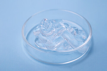 Closeup photography of niacinamide serum with bubbly structure in the petri dish.Cosmetics banner,copy space.