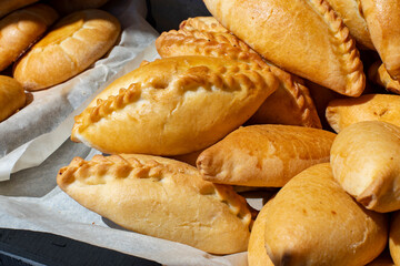 Golden pie stuffed with potato and cabbage, national Slavic pastry, horizontal photo