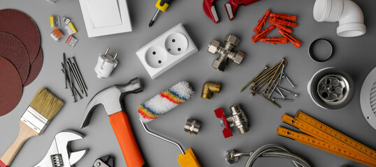 Fototapeta household hardware store items and construction tools on gray background. banner obraz