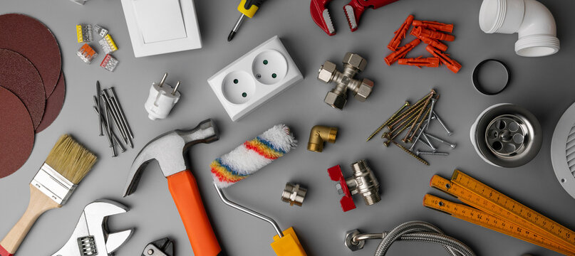household hardware store items and construction tools on gray background. banner