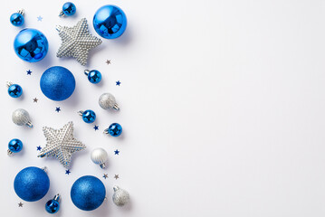 Christmas decorations concept. Top view photo of blue white silver baubles glowing star ornaments and confetti on isolated white background with copyspace