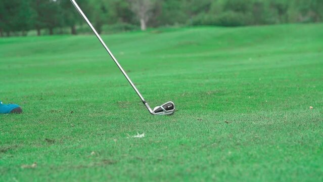 Slow motion of a putter hitting the golf ball