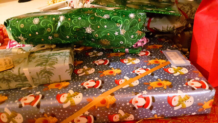 Christmas presents lying under the family christmas tree in December