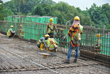 JOHOR, MALAYSIA -MAY 14, 2016: Group of construction workers working at the construction site at...