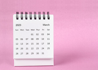 Fototapeta na wymiar The March 2023 desk calendar on pink color background.