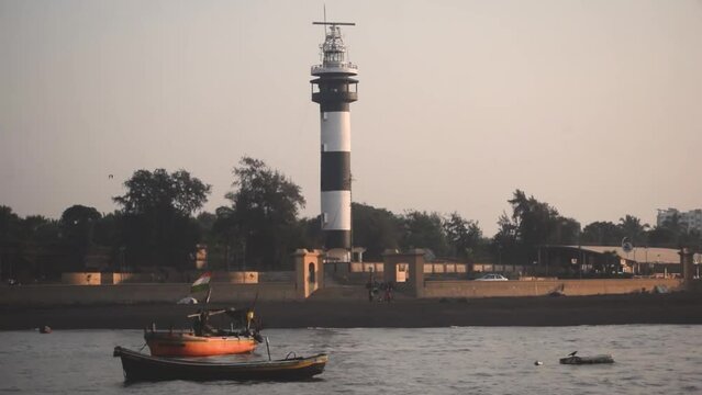 Lighthouse and Boats on the shore of Arabian sea at Daman , India