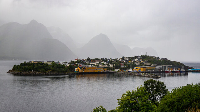 panorama of senja island, norway, overlooking the small island of husoy and its harbour; the famous norwegian fjords