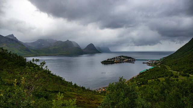 panorama of senja island, norway, overlooking the small island of husoy and its harbour; the famous norwegian fjords