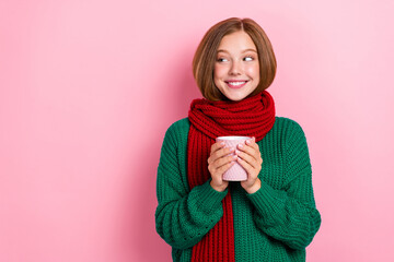 Photo of dreamy cute girl dressed knitted pullover arms red scarf drinking hot tea looking empty...