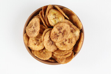 Fried banana chips in a white bowl on a white background
