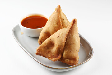 Veg Samosa - is a crispy and spicy Indian triangle shape snack which has crisp outer layer of maida filling of mashed potato, peas and spices