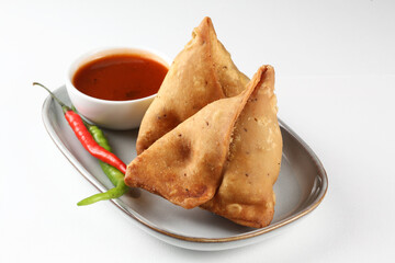 Veg Samosa - is a crispy and spicy Indian triangle shape snack which has crisp outer layer of maida filling of mashed potato, peas and spices