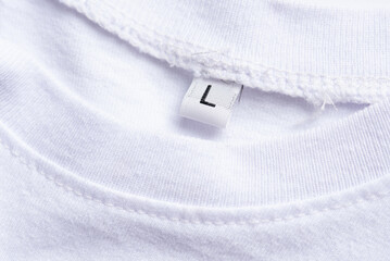 Close-up of a white t-shirt with label with the size