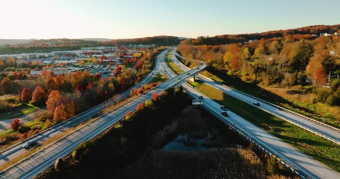 Afternoon aerial, drone, video of NY Route 17 just west of the diverging diamond interchange (DDI), located in Woodbury, NY, with a dolly move pulling away from subject.	