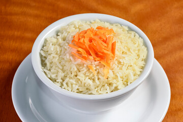 White rice garnish on wooden table.